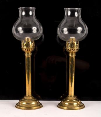 Appraisal: A pair of brass spring loaded candlesticks of column form