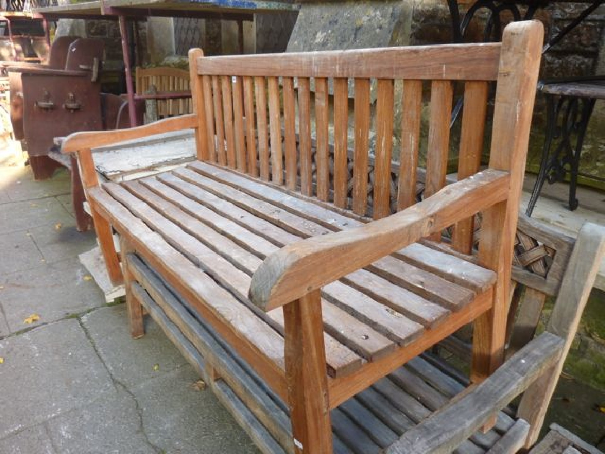 Appraisal: A good quality weathered contemporary teak three seat garden bench