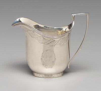 Appraisal: English silver creamer helmet form with squared handle engraved foliate