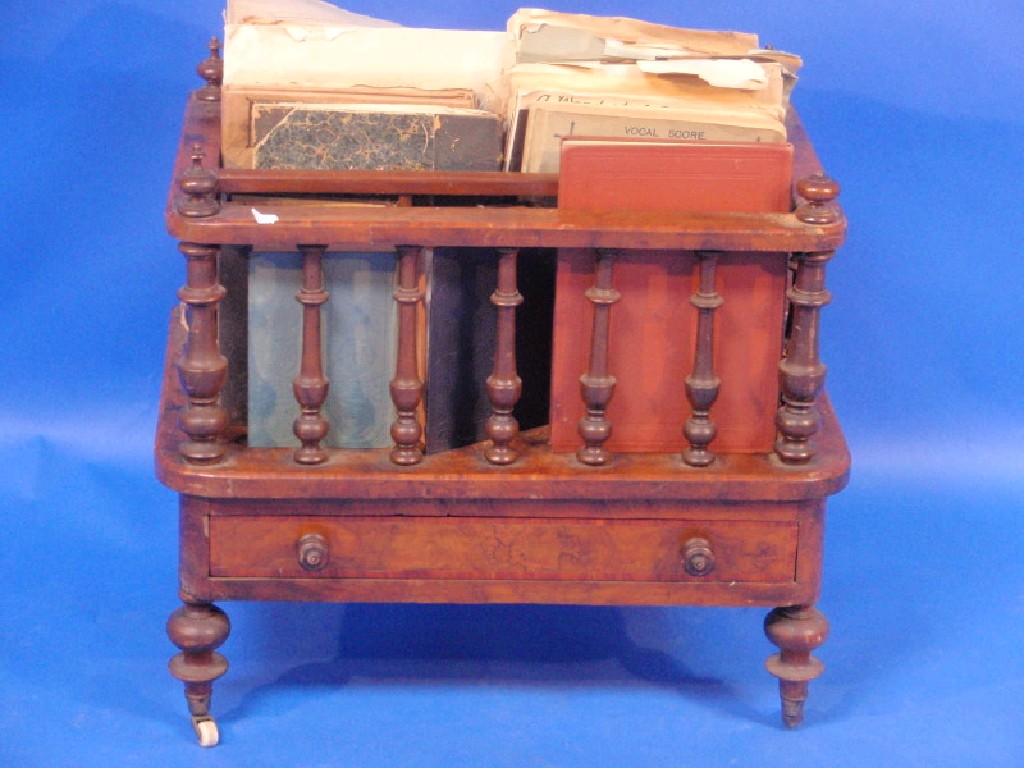 Appraisal: A Victorian walnut music Canterbury with spindle turned supports and