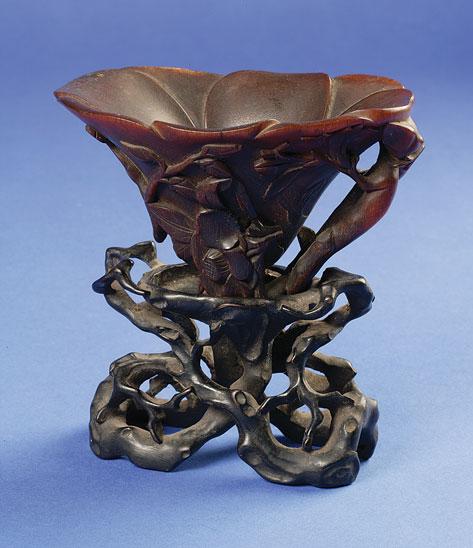 Appraisal: A CHINESE RHINOCEROS HORN LIBATION CUP with a shallow bowl