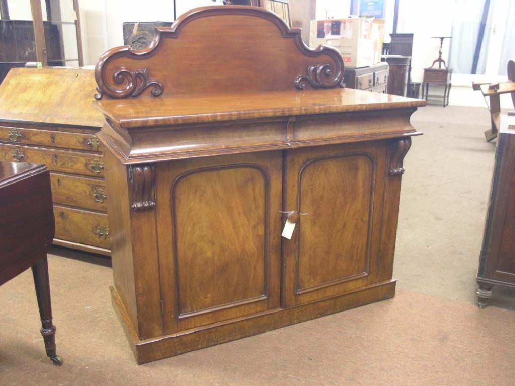 Appraisal: A Victorian mahogany chiffonier raised scroll-back above two frieze drawers