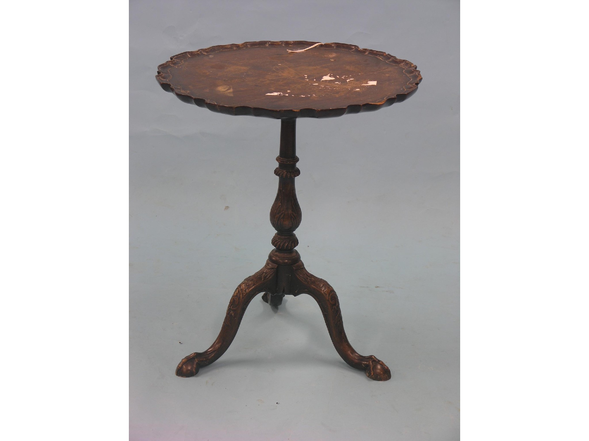 Appraisal: A George II-style mahogany tripod table pie-crust tilt-top on carved