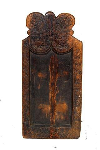 Appraisal: AN ANTIQUE TIBETAN CARVED WOODEN PRAYER BOARD with stylised foliate