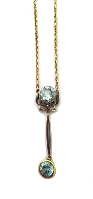 Appraisal: A gold and pale blue zircon set two stone pendant