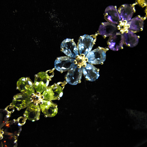 Appraisal: MULTI-COLOR GEMSTONE AND FOURTEEN KARAT GOLD DAISY MOTIF BRACELET The