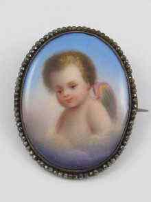 Appraisal: A porcelain brooch depicting a cherub set in cut steel