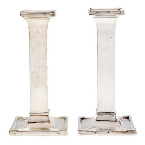 Appraisal: A pair of George V silver candlesticks of plain square