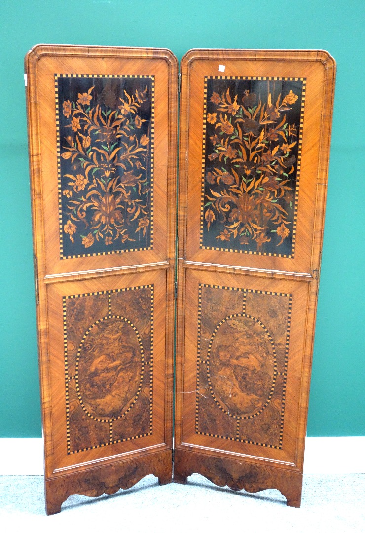 Appraisal: A figured walnut two fold draught screen with inset th