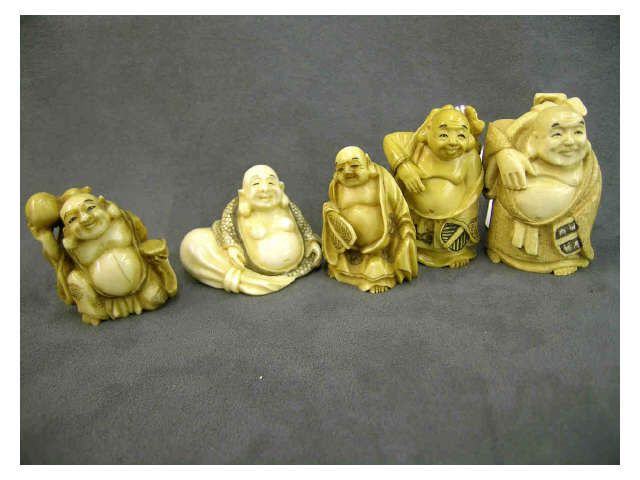 Appraisal: Five ivory netsuke possibly representing Hotei including Hotei sitting beside