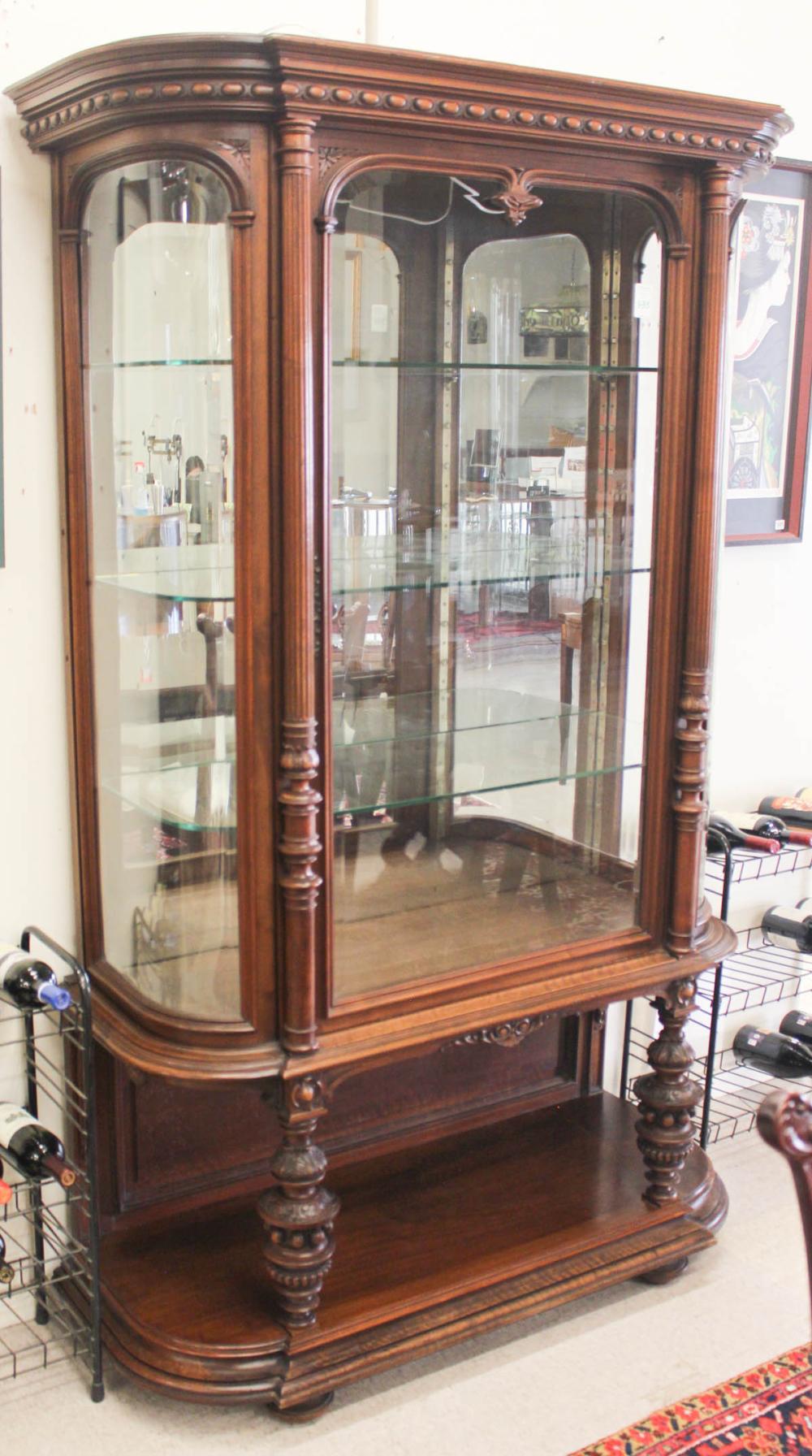 Appraisal: CARVED WALNUT AND CURVED GLASS CHINA CABINET ON STAND Renaissance