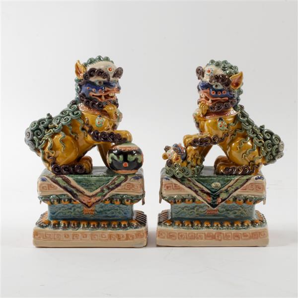 Appraisal: Pair Chinese glazed porcelain Foo Dog roof tile style figures