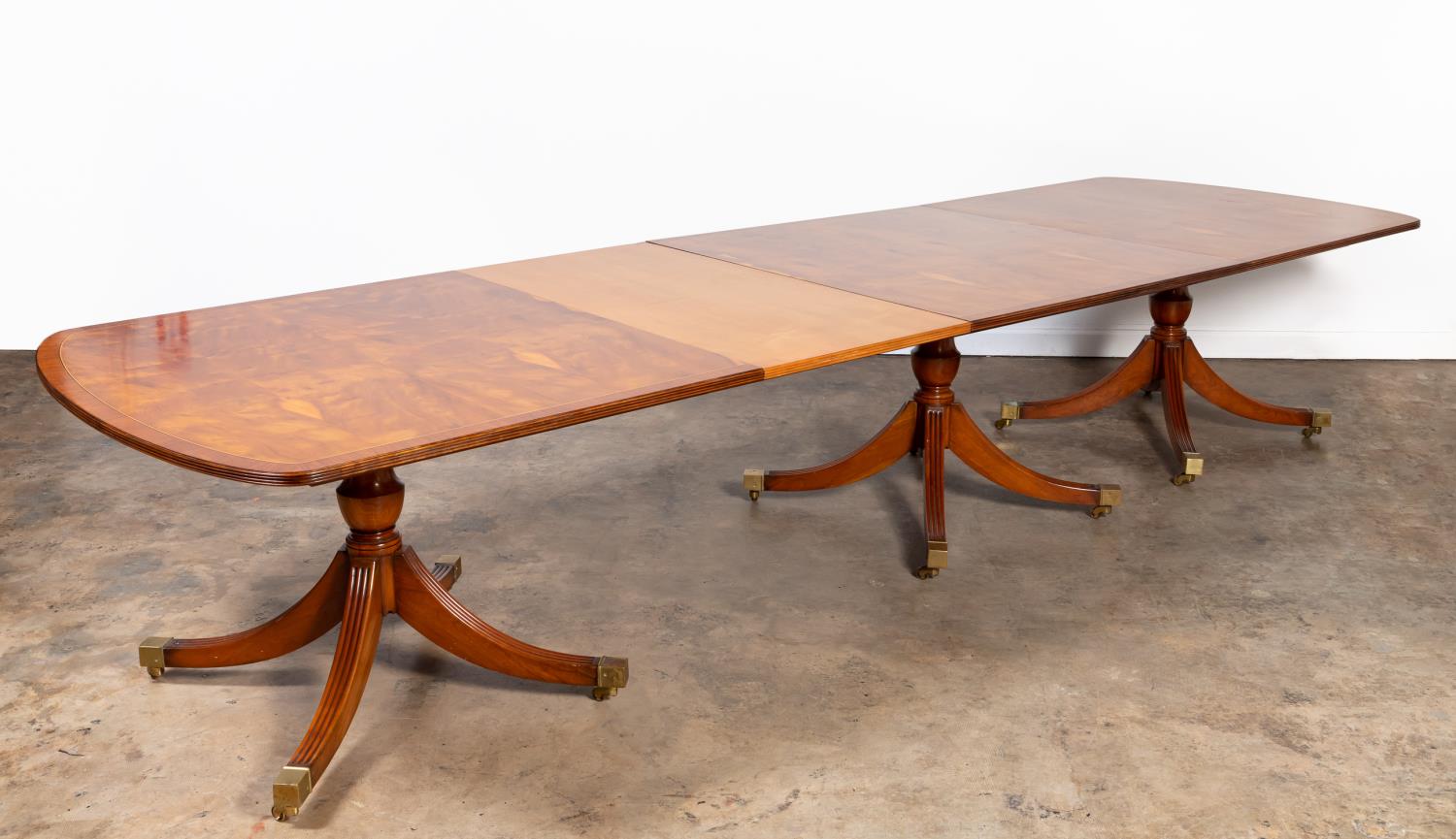 Appraisal: SMITH WATSON YEW TRIPLE-PEDESTAL DINING TABLE Smith Watson American founded