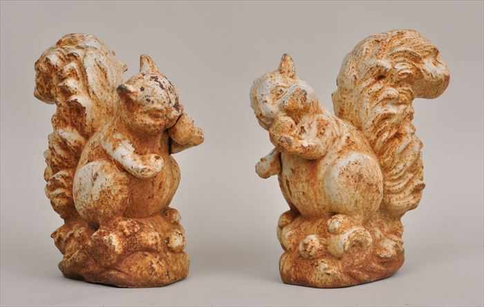 Appraisal: PAIR OF WHITE-PAINTED CAST-IRON SQUIRRELS Each modeled eating a nut