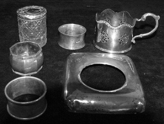 Appraisal: Three napkin rings a bottle holder the silver mounts for