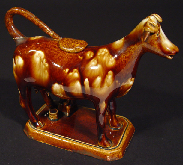 Appraisal: th century Staffordshire brown glazed cow creamer modelled with a