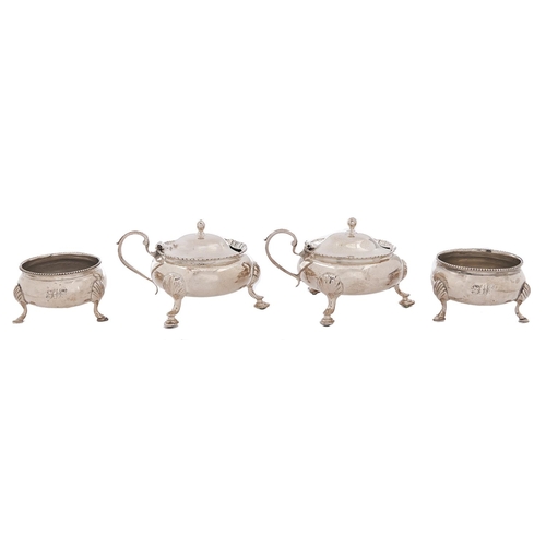 Appraisal: A pair of George V silver mustard pots on hoof