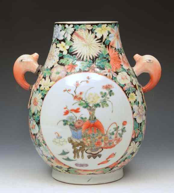 Appraisal: A CHINESE FAMILLE ROSE JAR with elephant mask handles decorated