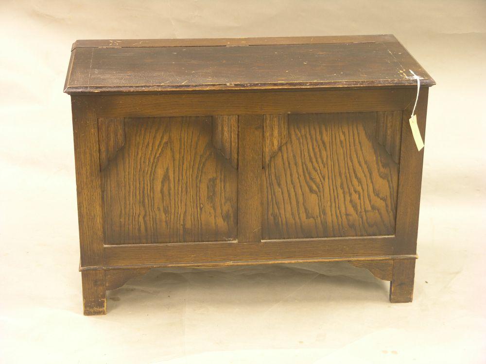 Appraisal: A dark oak coffer with panelled front ft in together