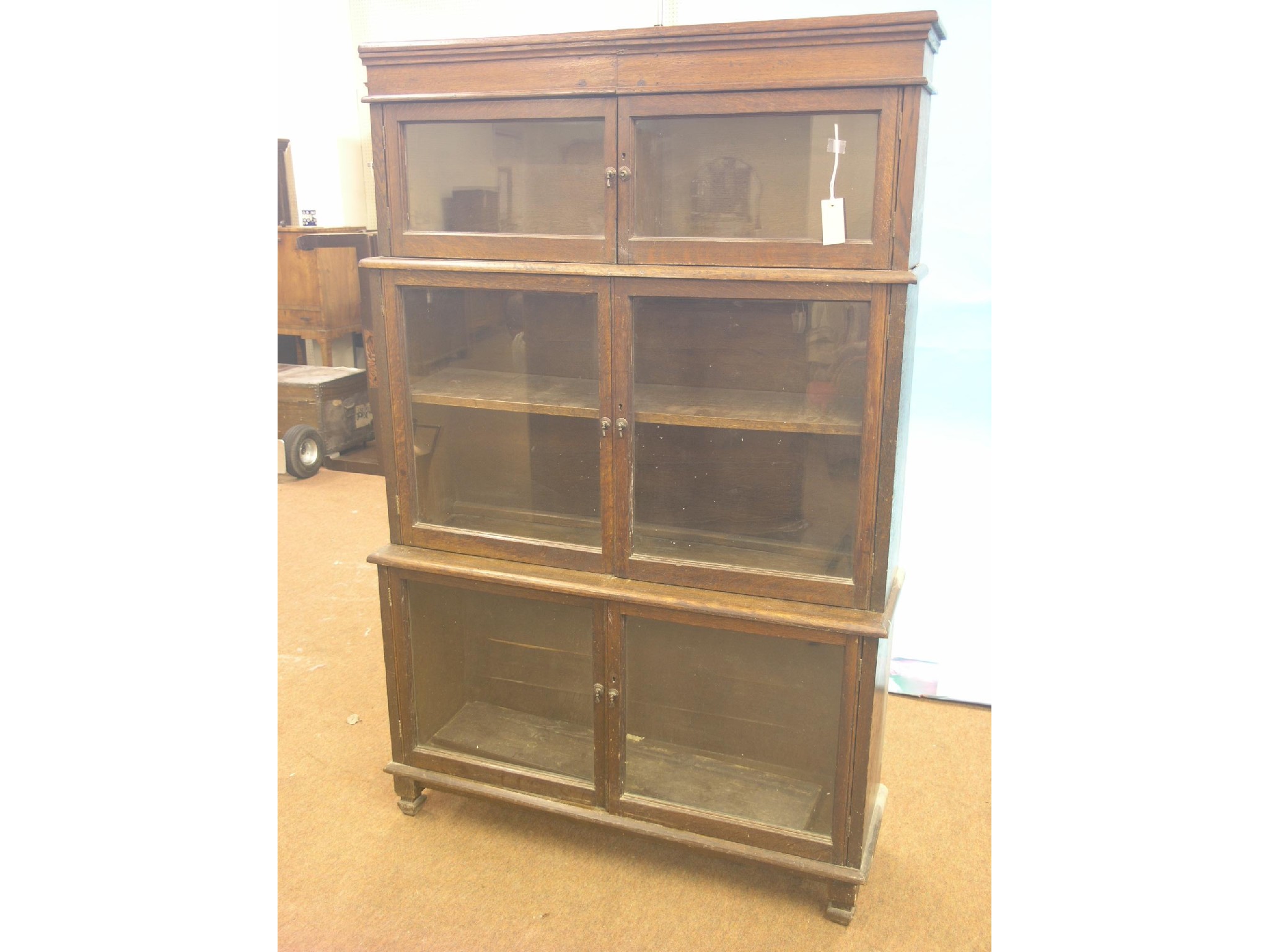 Appraisal: A dark oak sectional bookcase three pairs of glazed doors