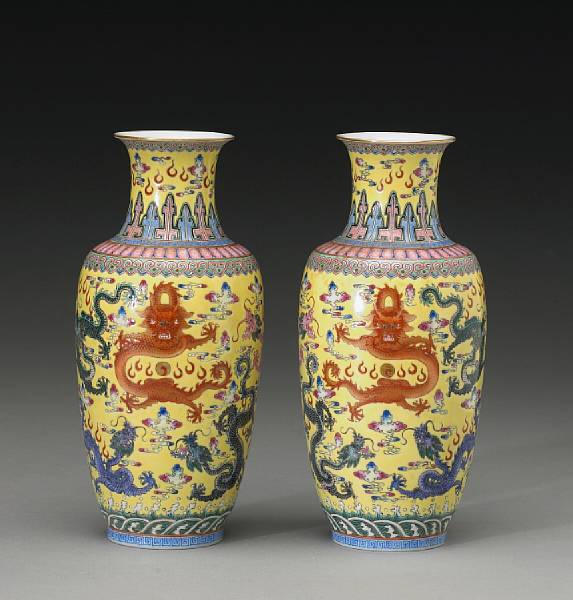 Appraisal: A pair of yellow ground enameled porcelain vases with 'nine