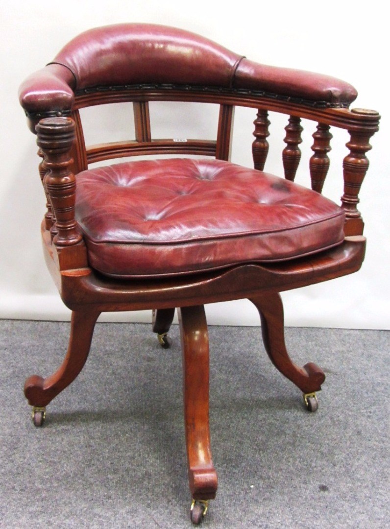 Appraisal: A Victorian walnut framed red leather upholstered tub back office