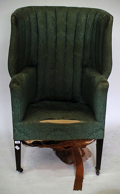 Appraisal: AN EDWARDIAN WING ARMCHAIR with tall curved back having blue