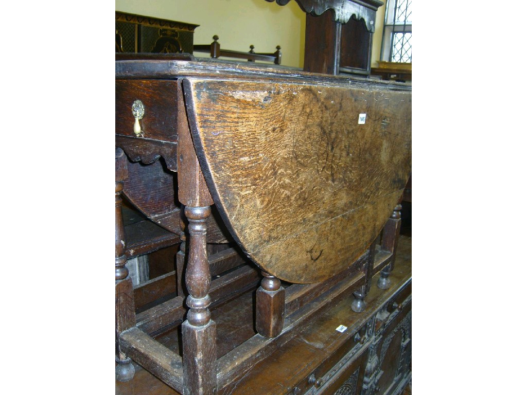 Appraisal: A Georgian oak oval drop leaf gateleg dining table raised