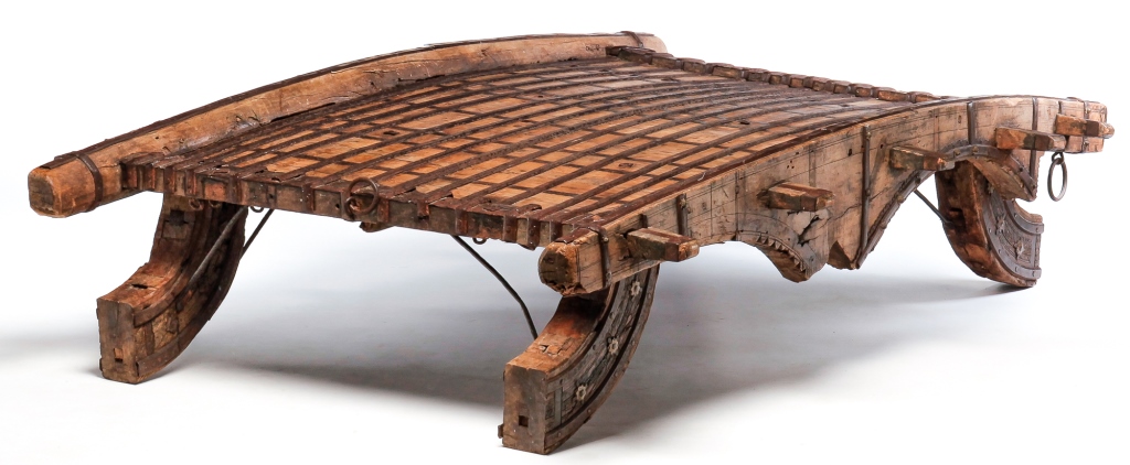 Appraisal: INDONESIAN HOWDAH COFFEE TABLE Late th-early th century Heavy hardwood