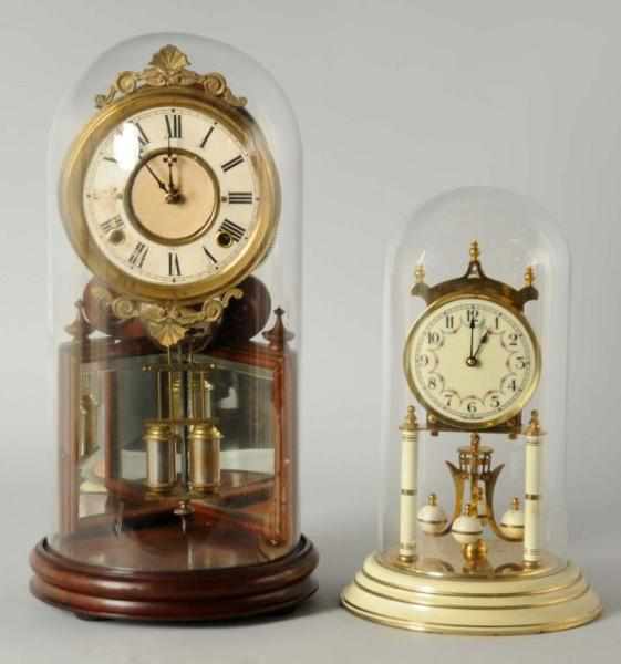 Appraisal: Lot of Brass Wood Skeleton Clocks Description Both in glass