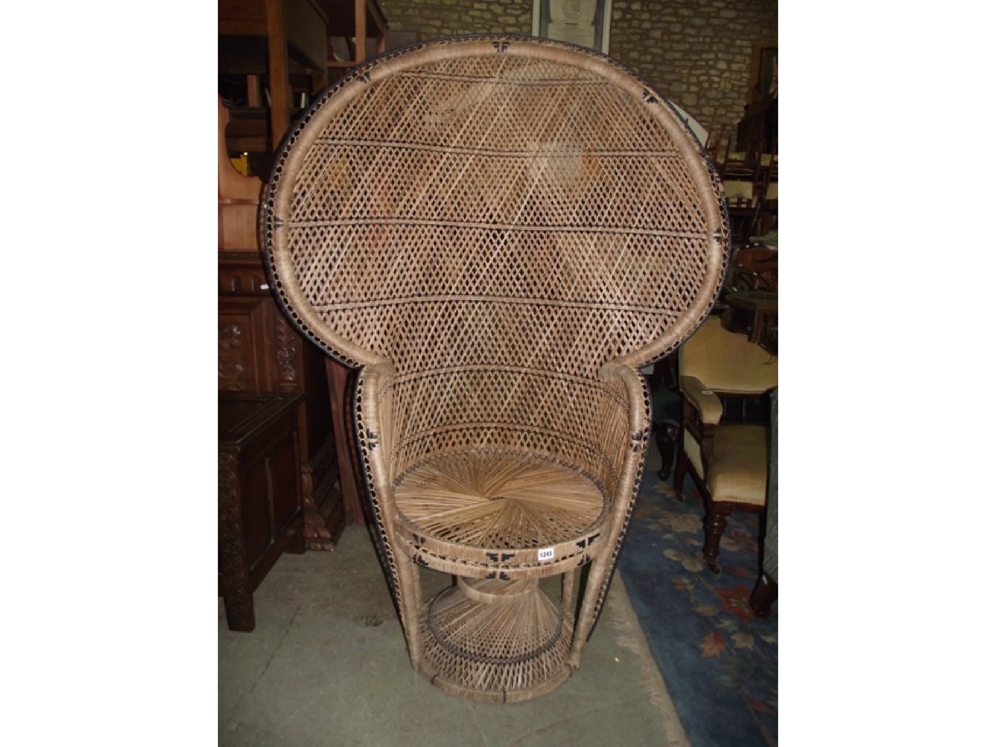 Appraisal: A wicker peacock type chair with shaped outline and circular