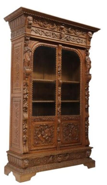 Appraisal: French carved oak bookcase late th c ornamented cornice flanked