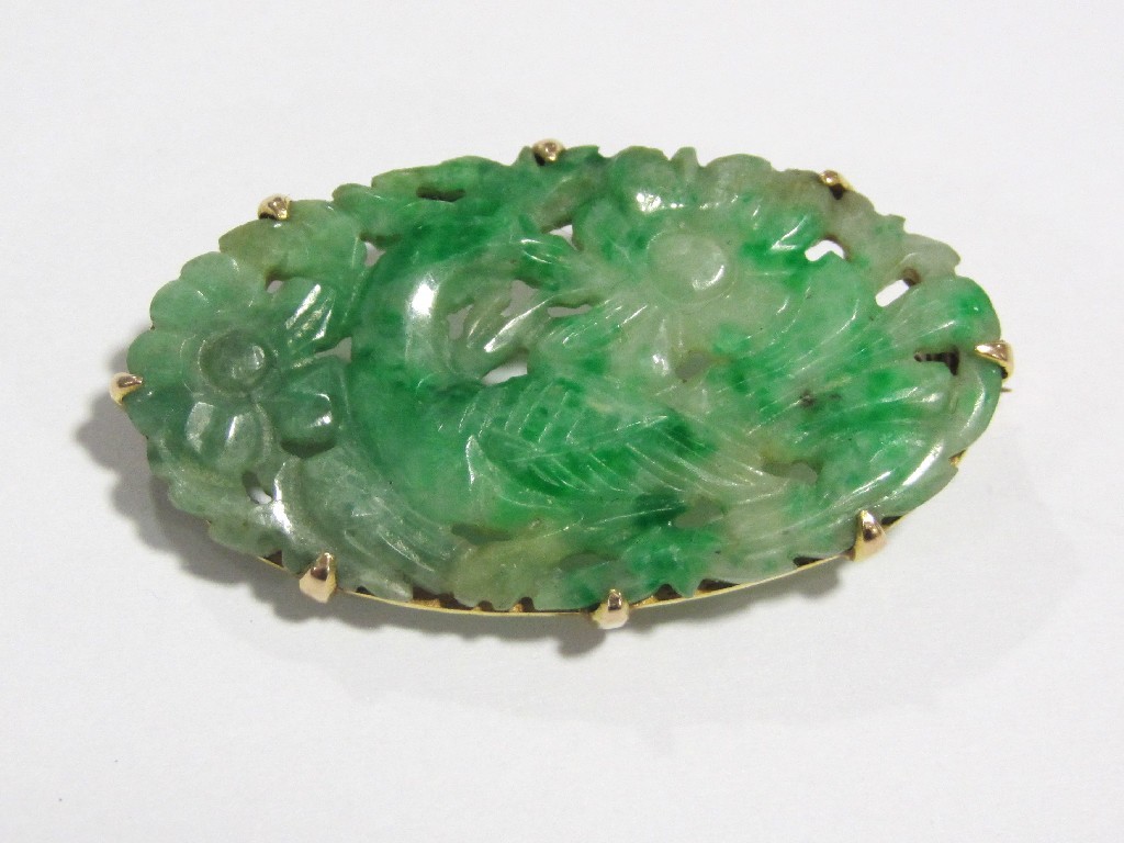 Appraisal: A Chinese carved jade oval brooch depicting a bird within