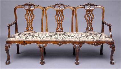 Appraisal: PORTUGUESE ROCOCO CARVED THREE-CHAIR-BACK SETTEE The serpentine shell-carved top rail