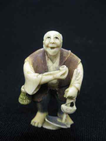 Appraisal: Carved Ivory Netsuke of Man with Pipe tools polychrome pants