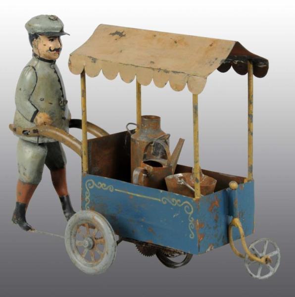 Appraisal: Tin Hand-Painted Man Pushing Cart Wind-Up Toy Description German Working