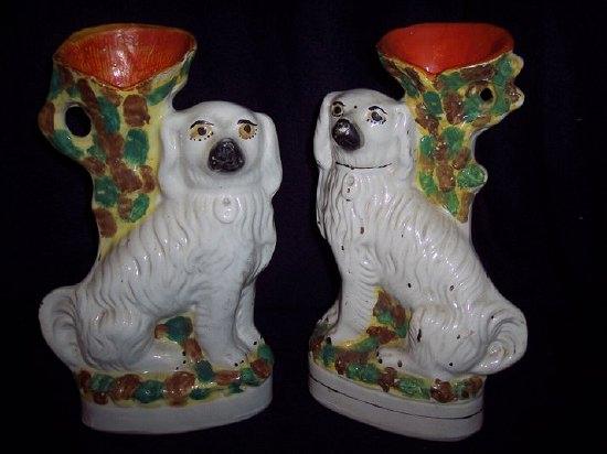 Appraisal: A pair of Staffordshire dog vases painted flowers and with