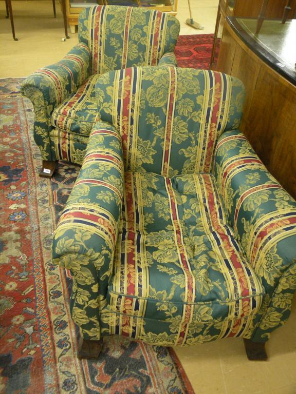 Appraisal: A pair of Edwardian deep seated armchairs each upholstered in