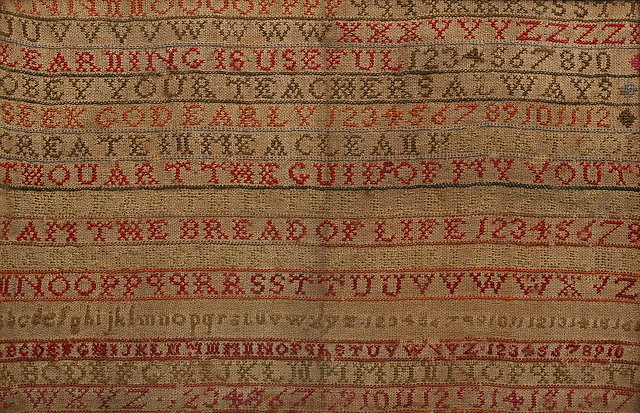 Appraisal: A VICTORIAN CHILD'S NEEDLEWORK SAMPLER decorated alphabetical and numerical horizontal