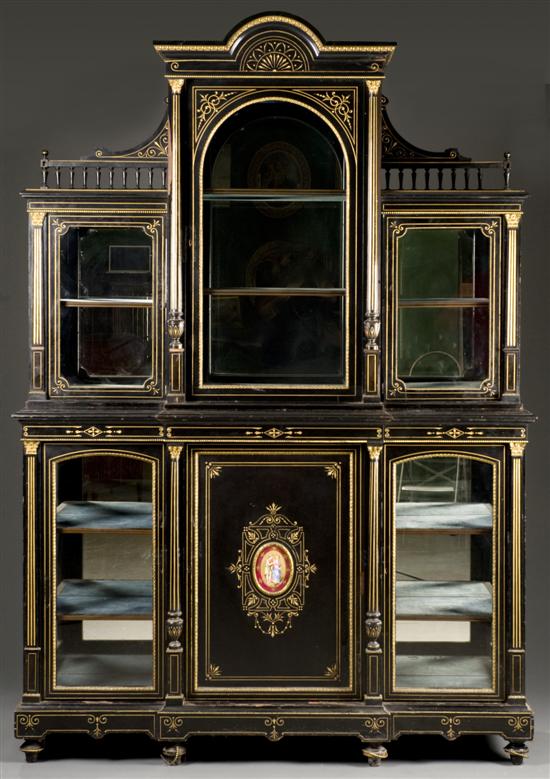 Appraisal: Victorian two-piece ebonized cabinet with gilded decoration Late th century