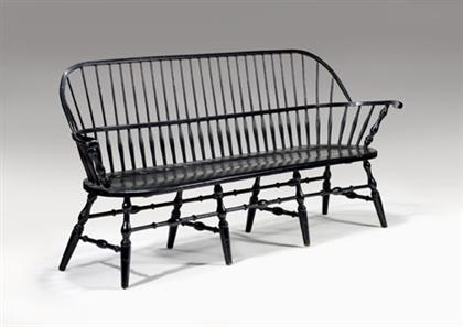 Appraisal: Black-painted Windsor settee pennsylvania With sack-back surrounding above a molded