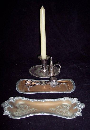 Appraisal: A chamber candlestick with extinguisher a candle snuffer and two