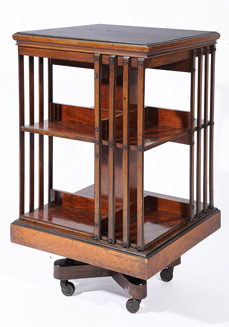 Appraisal: A LATE VICTORIAN WALNUT REVOLVING BOOKCASE with brass inlaid monogram