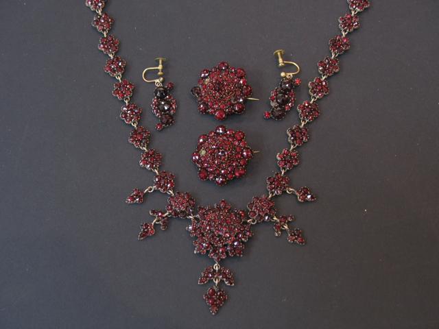 Appraisal: A TH CENTURY GARNET DEMI PARURE comprising a necklace each