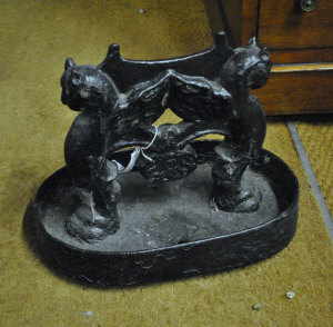 Appraisal: A Victorian cast iron boot scraper supported by gryphons