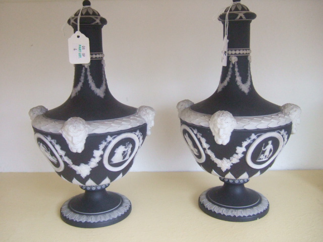 Appraisal: A pair of Wedgwood basalt ware vases and covers with