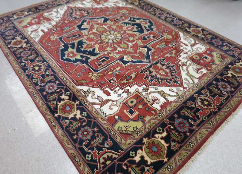 Appraisal: HAND KNOTTED ORIENTAL CARPET Persian Serapi design central geometric medallion