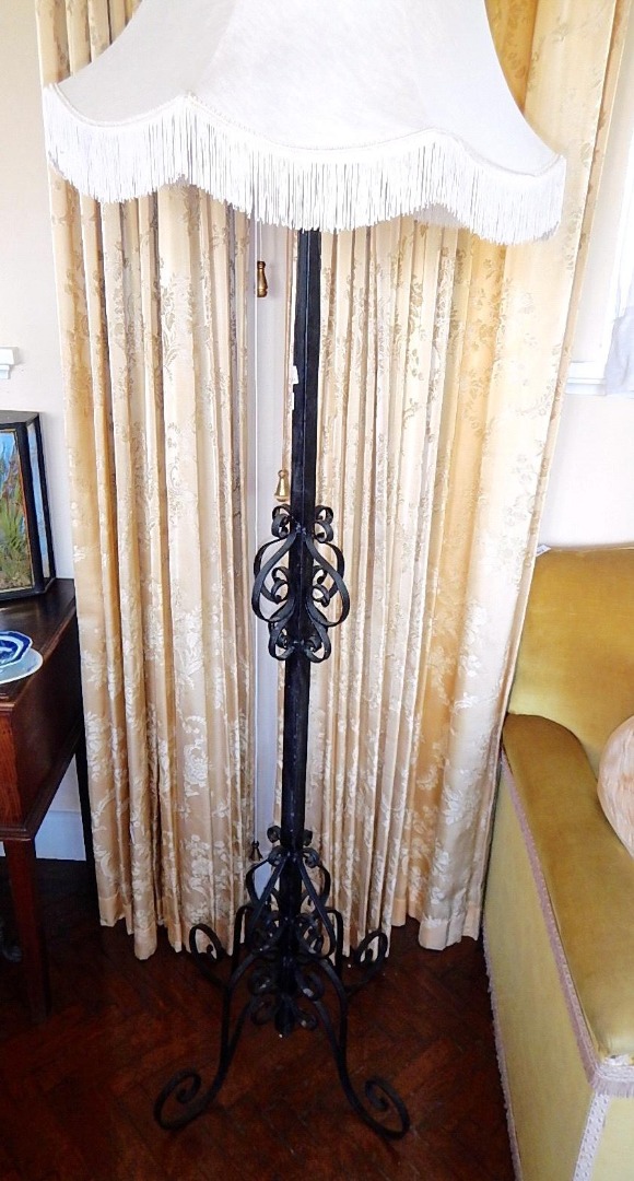 Appraisal: A wrought iron standard lamp with square section column and