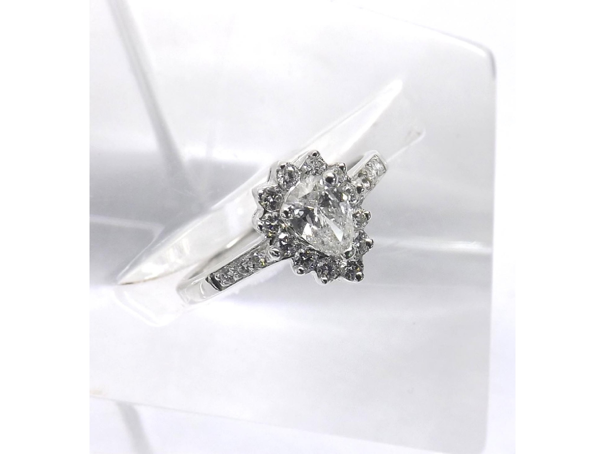 Appraisal: - -A Platinum pear and round-brilliant cut diamond cluster ring