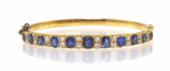 Appraisal: A Victorian Yellow Gold Sapphire and Diamond Hinged Bangle Bracelet